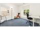 Sun-filled bedroom with large windows and neutral walls, offering versatile space for a home office at 128 Palmdale Ct, Holly Springs, NC 27540