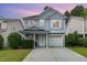 Charming blue home with a well-maintained front yard and an attached garage at 128 Palmdale Ct, Holly Springs, NC 27540
