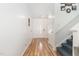 Clean and well-lit foyer with hardwood floors, staircase and white walls at 128 Palmdale Ct, Holly Springs, NC 27540