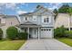 Charming two-story home with light blue siding, white trim, and a well-maintained front yard at 128 Palmdale Ct, Holly Springs, NC 27540