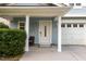 Cozy covered porch featuring a chair, white columns, and views of the front yard at 128 Palmdale Ct, Holly Springs, NC 27540