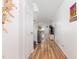 Bright hallway featuring wood flooring and a view of the living area at 128 Palmdale Ct, Holly Springs, NC 27540