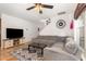 Comfortable living room featuring hardwood floors, and a gray sectional sofa at 128 Palmdale Ct, Holly Springs, NC 27540