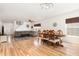 Open-concept living and dining area with hardwood floors, modern furnishings at 128 Palmdale Ct, Holly Springs, NC 27540