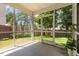 Inviting screened porch offering views of the fenced backyard, perfect for outdoor living at 128 Palmdale Ct, Holly Springs, NC 27540