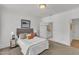 Well-lit bedroom with ensuite bathroom features a cozy bed and neutral tones at 1310 Durlain Dv # 103, Raleigh, NC 27614