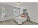 Bright bedroom features large windows, neutral decor, and comfortable furnishings at 1310 Durlain Dv # 103, Raleigh, NC 27614