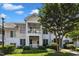 Charming two-story condo featuring double balconies, landscaped grounds, and a welcoming exterior paint scheme at 1310 Durlain Dv # 103, Raleigh, NC 27614