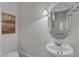 Clean half bathroom featuring a vessel sink, decorative mirror, and neutral wall color at 1310 Durlain Dv # 103, Raleigh, NC 27614
