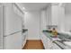 Efficient kitchen design with white cabinetry, ample counter space, and modern appliances at 1310 Durlain Dv # 103, Raleigh, NC 27614