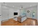Open living area showcasing hardwood floors, neutral decor, and natural light from the windows and door at 1310 Durlain Dv # 103, Raleigh, NC 27614