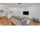 Inviting living room featuring hardwood floors, a comfortable couch, and a view into the adjacent kitchen area at 1310 Durlain Dv # 103, Raleigh, NC 27614