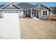 Charming single-Gathering home featuring stone accents, a two-car garage, and a well-manicured lawn at 148 Merrifield Ln # 128, Garner, NC 27529