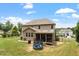 A spacious backyard with a well-maintained lawn, a screened-in porch, and a blue trampoline at 150 Saint Mellion St, Raleigh, NC 27603