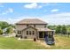 Expansive backyard featuring a covered porch, a trampoline, and lush lawn at 150 Saint Mellion St, Raleigh, NC 27603