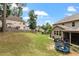 Well-kept backyard featuring lush green grass, mature trees, and a blue trampoline at 150 Saint Mellion St, Raleigh, NC 27603