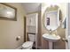 Cozy powder room with pedestal sink, storage cabinet, and neutral wall color at 150 Saint Mellion St, Raleigh, NC 27603