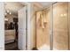 Well-lit bathroom with a glass door shower and a peek into the walk-in closet at 150 Saint Mellion St, Raleigh, NC 27603