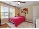 Bright bedroom featuring a cozy bed, a colorful rug, and natural light, creating a warm and inviting space for relaxation at 150 Saint Mellion St, Raleigh, NC 27603