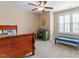 Cozy bedroom with a wooden bed frame, a study desk, and a window, ideal for both rest and study at 150 Saint Mellion St, Raleigh, NC 27603