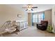 Bright Bedroom featuring a white crib, a comfortable rocking chair, and natural light, creating a warm and inviting space at 150 Saint Mellion St, Raleigh, NC 27603