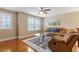 Comfortable upstairs bonus room with a ceiling fan, large windows, and cozy seating at 150 Saint Mellion St, Raleigh, NC 27603