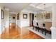 Elegant dining room with hardwood floors, coffered ceiling, and wainscoting details at 150 Saint Mellion St, Raleigh, NC 27603