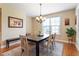 Informal dining area with hardwood floors, elegant chandelier, and large window at 150 Saint Mellion St, Raleigh, NC 27603
