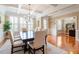 Open-concept dining room with coffered ceilings, hardwood floors, and natural light at 150 Saint Mellion St, Raleigh, NC 27603