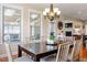 Inviting dining room featuring a dark wood table, elegant chandelier, and lots of natural light at 150 Saint Mellion St, Raleigh, NC 27603