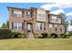 Inviting two-story home with brick and stone facade, manicured lawn, and lovely landscaping at 150 Saint Mellion St, Raleigh, NC 27603