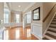 Bright foyer features hardwood floors, white wainscoting, and a beautiful front door at 150 Saint Mellion St, Raleigh, NC 27603