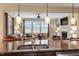 Kitchen island with granite countertops and stainless steel dishwasher looks into a cozy Gathering room at 150 Saint Mellion St, Raleigh, NC 27603