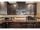 Close up view of the gourmet kitchen featuring stainless steel appliances, custom cabinets and granite countertops at 150 Saint Mellion St, Raleigh, NC 27603
