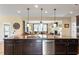 Open kitchen with a granite island overlooks the cozy Gathering room with fireplace and large windows at 150 Saint Mellion St, Raleigh, NC 27603