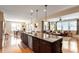 A view of the kitchen, with stainless steel appliances, which opens up to the dining room and living room at 150 Saint Mellion St, Raleigh, NC 27603