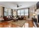 Spacious living room featuring a large leather sofa, hardwood floors, and ample natural light at 150 Saint Mellion St, Raleigh, NC 27603