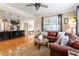 Open-concept living room and kitchen with hardwood floors, comfortable seating, and ample natural light at 150 Saint Mellion St, Raleigh, NC 27603