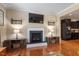 Living room featuring a fireplace, hardwood floors, and elegant decor at 150 Saint Mellion St, Raleigh, NC 27603