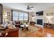 Bright living room featuring a fireplace, television, and comfortable seating with hardwood floors and natural light at 150 Saint Mellion St, Raleigh, NC 27603
