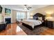 Inviting main bedroom with a dark wood bed frame, fireplace, sitting area and lots of natural light at 150 Saint Mellion St, Raleigh, NC 27603