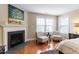 Comfortable main bedroom features a cozy sitting area by the fireplace and large window at 150 Saint Mellion St, Raleigh, NC 27603
