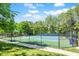 Well-maintained tennis courts surrounded by lush greenery and community amenities at 150 Saint Mellion St, Raleigh, NC 27603