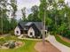 An aerial view of an elegant home surrounded by lush trees and landscaping showing off the curb appeal at 153 W Beech Slope Ct, Chapel Hill, NC 27517