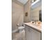 Updated half bath with white vanity, modern fixtures, and tiled floors at 153 W Beech Slope Ct, Chapel Hill, NC 27517