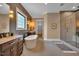 Bathroom boasts soaking tub, walk-in shower, stylish tile and natural light at 153 W Beech Slope Ct, Chapel Hill, NC 27517