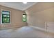 Empty bedroom featuring two windows letting in lots of natural light and neutral walls at 153 W Beech Slope Ct, Chapel Hill, NC 27517