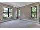 Bedroom featuring plush carpeting and large windows offering plenty of natural light at 153 W Beech Slope Ct, Chapel Hill, NC 27517