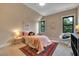 Cozy bedroom with colorful rug, comfortable bed, and a fluffy chair at 153 W Beech Slope Ct, Chapel Hill, NC 27517