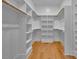 Walk-in closet featuring wooden shelves and drawers for optimal storage at 153 W Beech Slope Ct, Chapel Hill, NC 27517